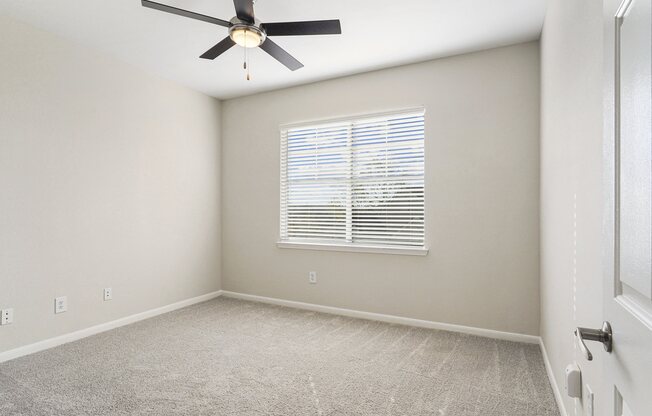 an empty room with a ceiling fan and a window at The Legends at Eagle Mountain Lake, Fort Worth, Texas