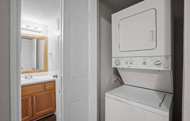 a white washer and dryer in a bathroom