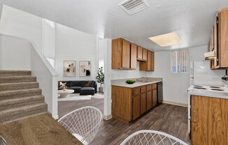 Model Kitchen with Wood-Style Flooring at District at Fiesta Park Apartments located in Mesa, AZ.