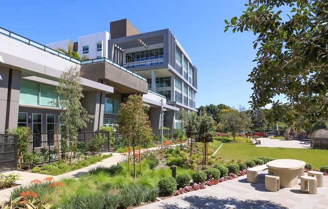 A modern building with a green lawn in front.