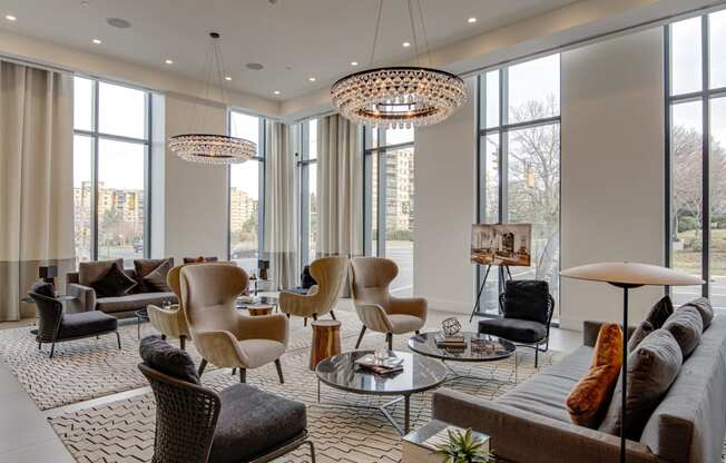 a living room filled with furniture and large windows