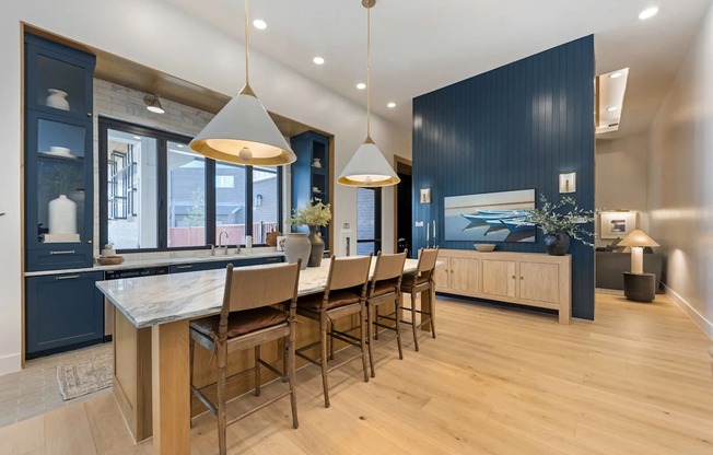 A modern kitchen with a dining table and chairs.