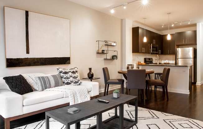 a living room and kitchen with a couch and a table
