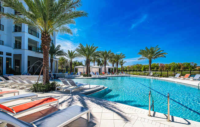 a swimming pool with lounge chairs and palm treesat Altis Grand Suncoast, Florida