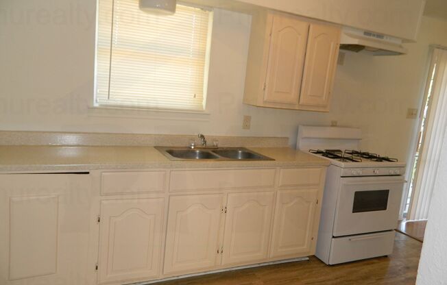 AVAILABLE NOW!!! MOVE IN SPECIAL $500 OFF ON THE FIRST MONTH'S RENT! Classic 4-Bed, 1.75-Bath Brick Home With Laminate Wood Floors