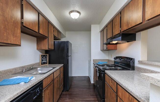 a modern kitchen with stainless steel appliances and wooden cabinets