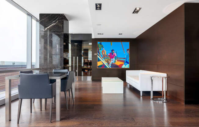 a colorful painting hangs on the wall in the dining room
