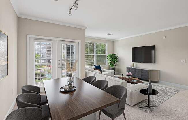 A modern dining room with a wooden table and grey chairs.