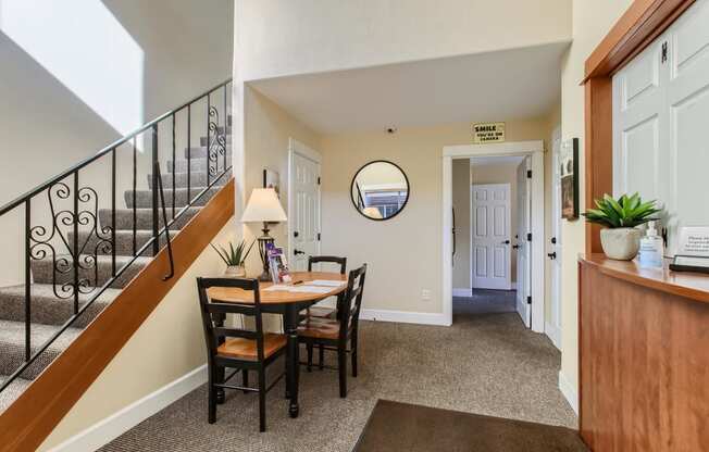 a dining room with a table and chairs and a staircase