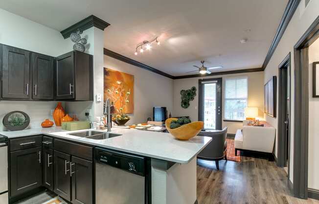 the view of a kitchen and living room with a couch and a sink