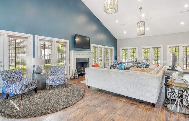 a living room with blue walls and a fireplace at Reserve of Jackson Apartment Homes, Jackson, MS