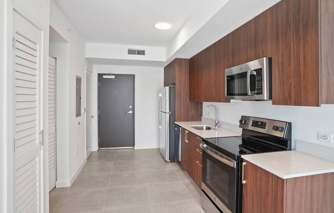 a kitchen with a stove top oven next to a refrigerator