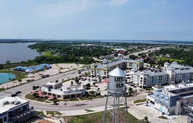 an aerial view of a city with buildings and a water tower