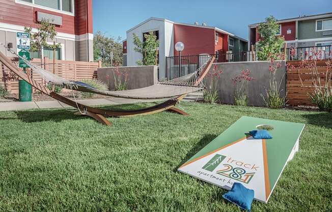 a yard with a hammock and a sign in the grass