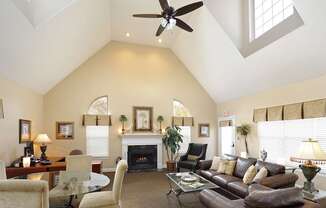 A living room with a fireplace and a ceiling fan.at Summerland Heights, Woodbridge, VA  
