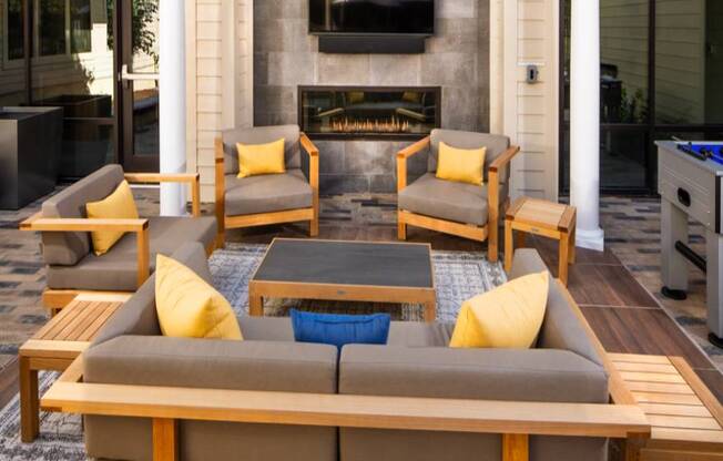 A patio with a fireplace and furniture.