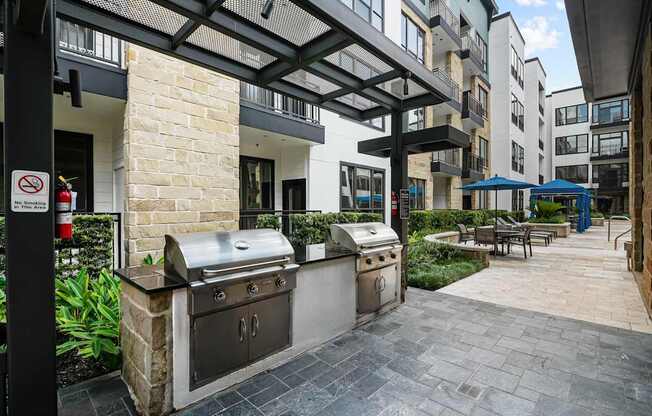 A patio with a grill and a no smoking sign.