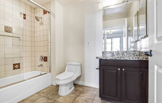 a bathroom with a toilet and a shower and a sink