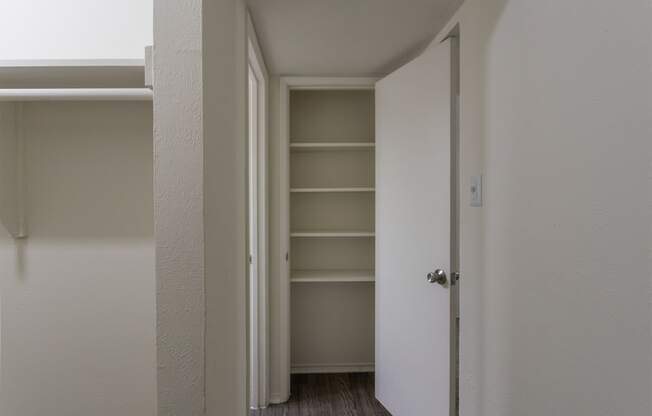 This is a photo of the primary bedroom linen closet in the 970 square foot 2 bedroom, 2 bath apartment at Preston Park Apartments in Dallas, TX