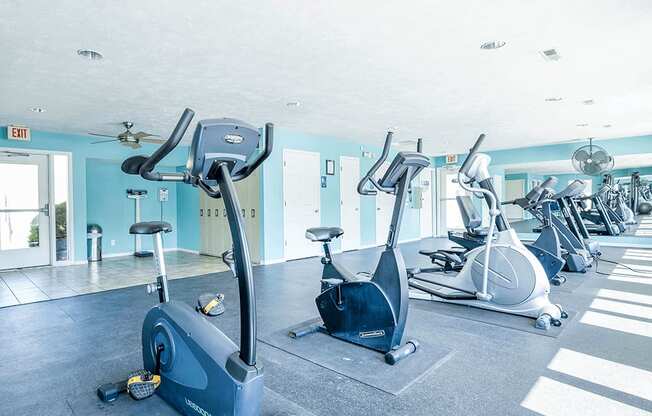 a row of exercise bikes in a gym