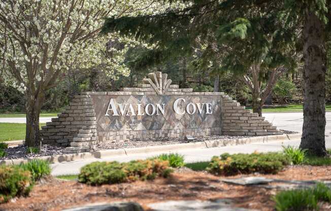 a sign for avlon cove on the side of a road