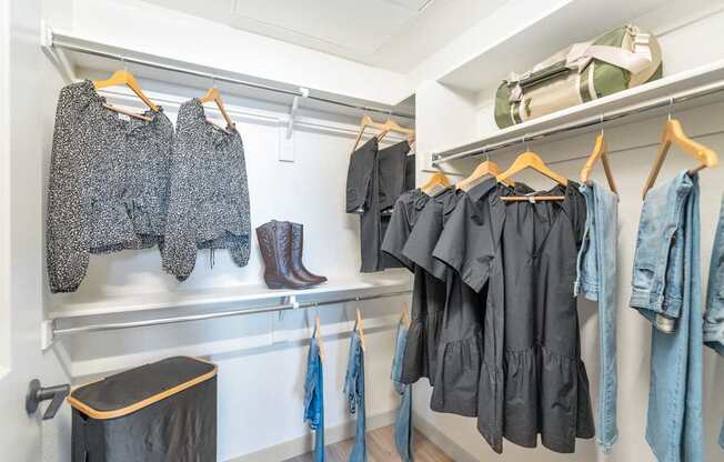 Clothes hanging on a rack in a room.