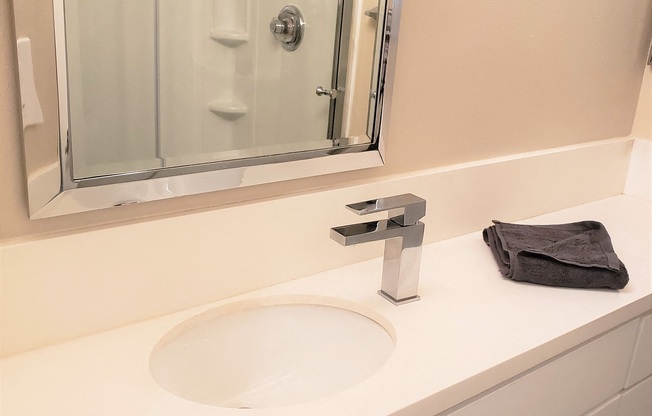 Master Bathroom with a modern round standing shower in the Ebony a 2BR 2BA