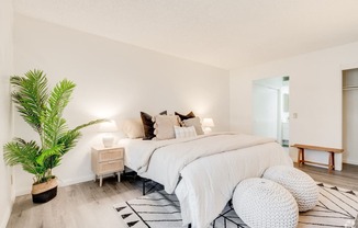 a bedroom with a bed and a potted plant at Alosta Place, Azusa, CA