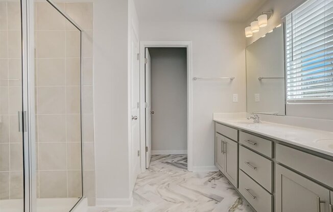 a bathroom with a large mirror and a walk in shower