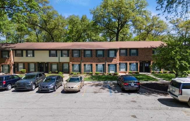 a large brick building with cars parked in front of it