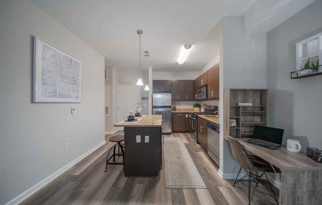 a kitchen with wooden cabinets and granite countertops at Harbor Pointe in Bayonne, NJ