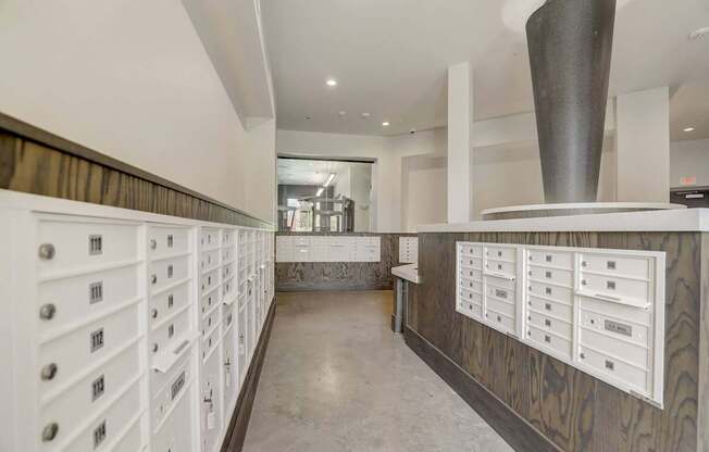 A long hallway with white drawers on the wall at Infinity on the Point Apartments, Dallas, TX
