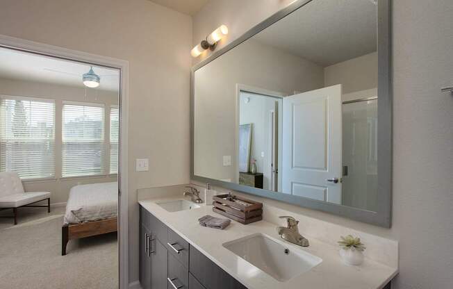Bathrooms include quartz countertops, dual vanities and framed mirrors