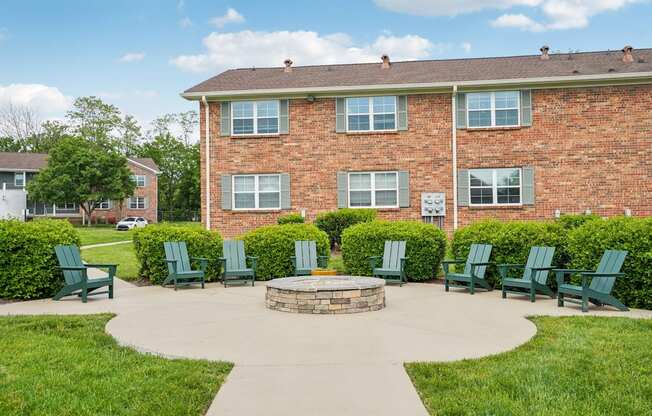 A brick building with a green lawn in front.
