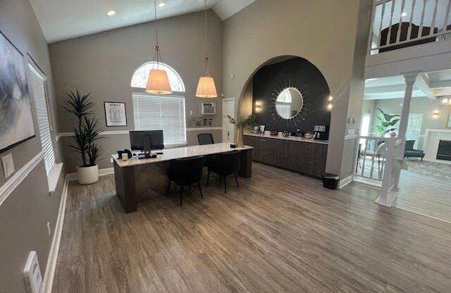 a large room with a desk and a mirror in it