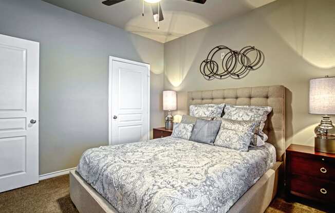 model bedroom with ceiling fan and carpet and queen size bed and walk-in closet