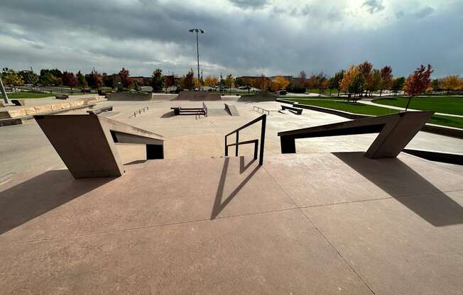 Skate park with ramps and a pole.