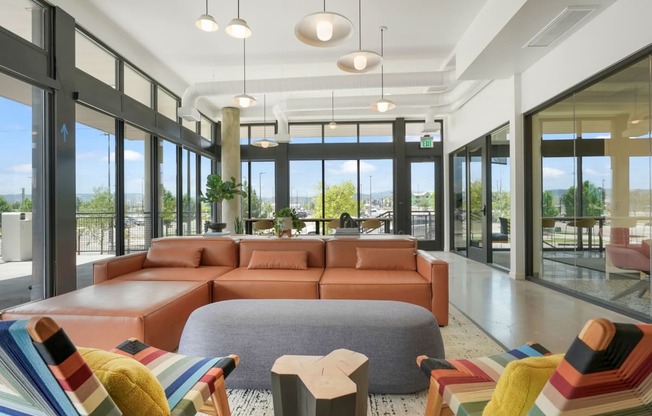 a living room filled with furniture and a large window