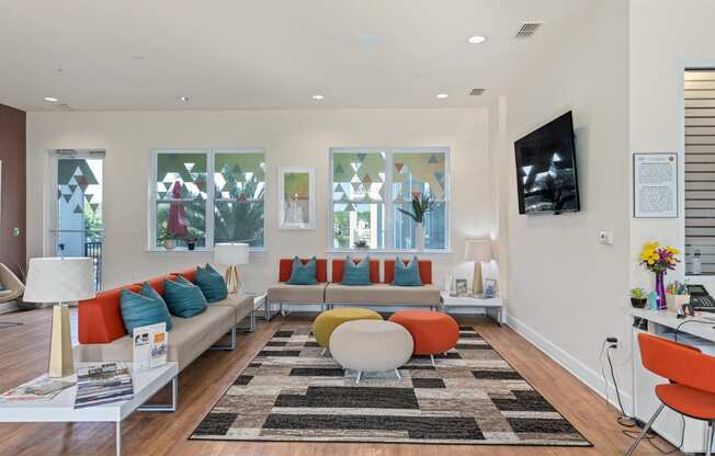 a living room with couches and chairs and a television