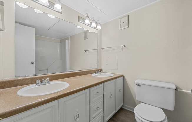 the preserve at ballantyne commons apartment bathroom with two sinks and a toilet at Brookside Apartments, Texas