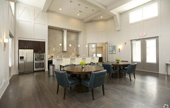 A modern dining room with a large table and chairs.