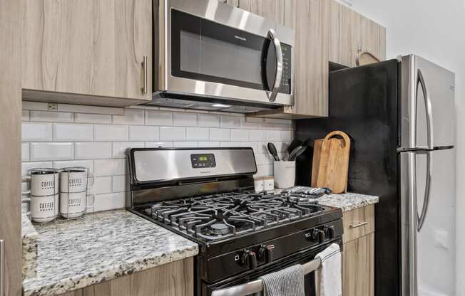 a kitchen with a stove top oven next to a refrigerator