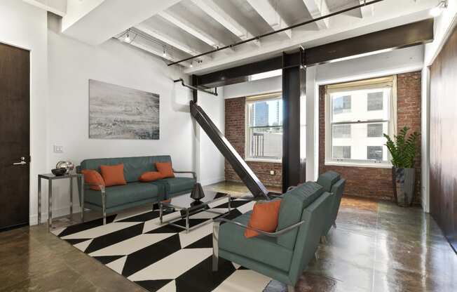 a living room with a checkered floor and two green couches