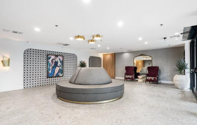 a lobby with a round couch and seating at Vera Cortez Hill, San Diego, 92101