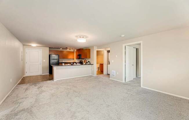 A living room with a television and a bar area.