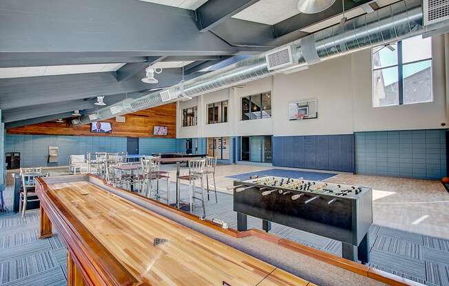 a large room with a foosball table and ping pong table