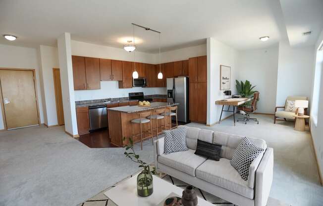 a living room and kitchen with a couch and a table