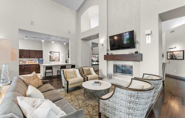 A living room with a grey couch and a fireplace.