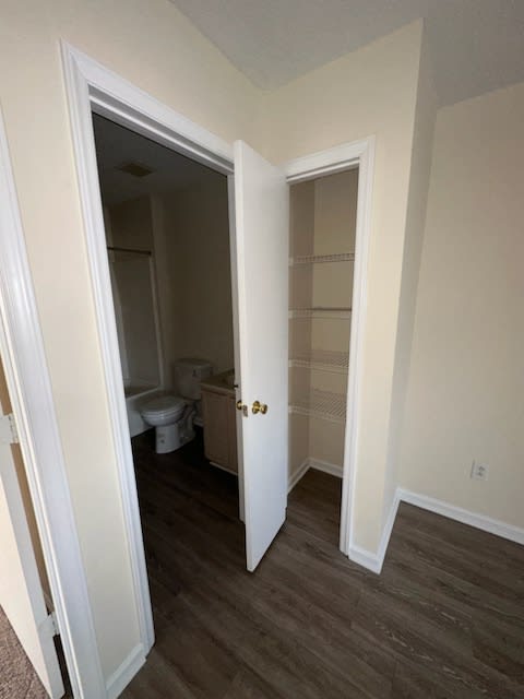 a bathroom with a toilet and a door open