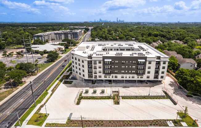 A large white building with a parking lot in front of it.